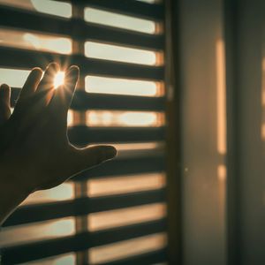 Soft morning sunlight through window blinds